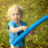 "An adorable photo of a 3-year-old boy, looking straight at the camera with a big, cheerful smile on his face. He has rosy cheeks, sparkling eyes, and his hair is a little messy, which makes him look even more endearing. The background is blurred, and it's not clear where the photo was taken, but it looks like the boy is outdoors, perhaps in a park or garden. The sunlight creates a warm and inviting feel to the image, and the boy's expression is full of joy and innocence. It's a heartwarming moment that captures the beauty of childhood.